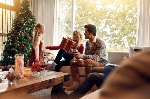 Family at home on christmas eve exchanging gifts