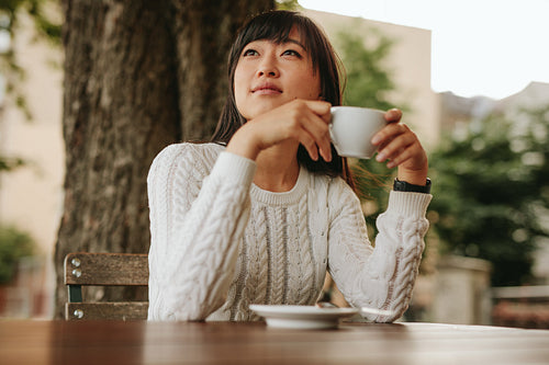 Chinese female having coffee at cafe