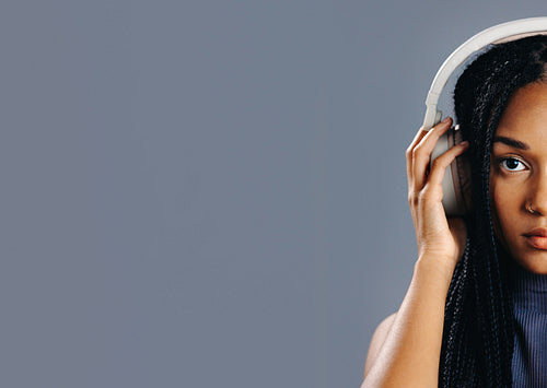 Portrait of a girl listening to music on wireless headphones