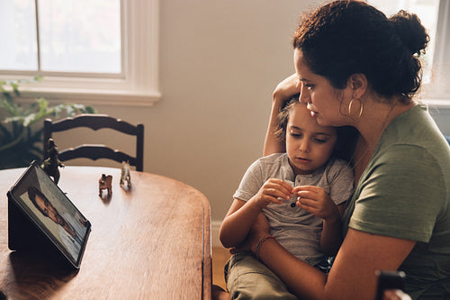 Mother taking online consultation from a doctor on her son sickn