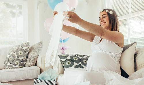 Pregnant woman with presents at baby shower party