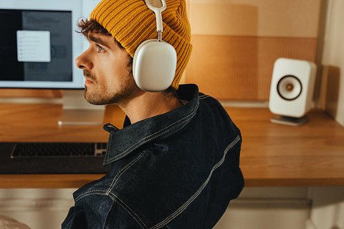 Working with headphones at a computer desk in a office space