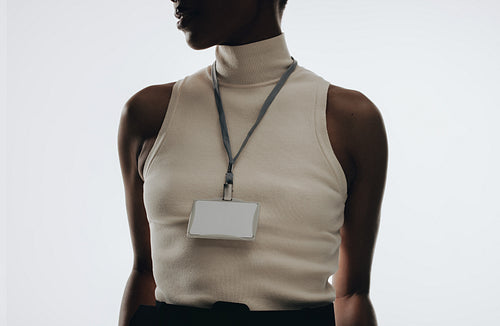 Person wearing blank lanyard badge for event and branding mockups