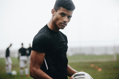 Portrait of a football player standing on field