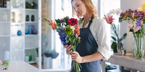 Woman working at indoor plant nursery