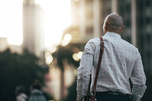 Businessman walking on street to office