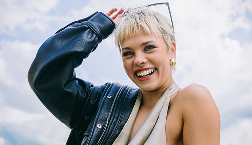 Leather jacket and sunglasses: joyful woman in street style