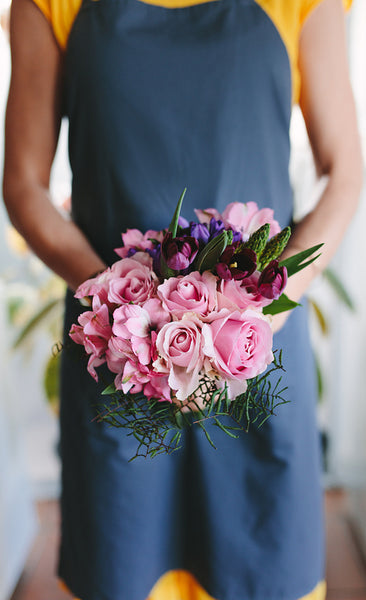 Female florist holding mixed flower bouquet