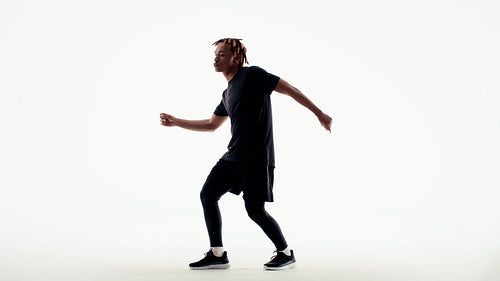 Energetic male dancer performs captivating hip hop choreography against a clean white studio backdrop