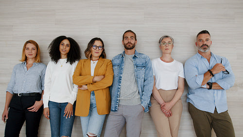 Casual and confident: Coworkers stand together in an office