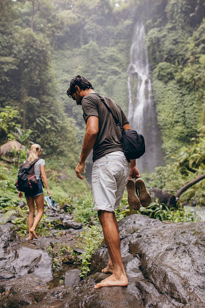 Young couple walking through mountain trail