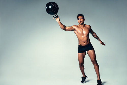 African male workout with a medicine ball