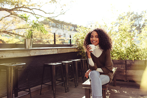 Woman drinking coffee at a coffee shop