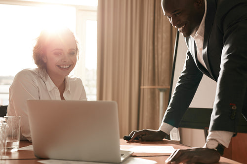 Young business team working together on laptop