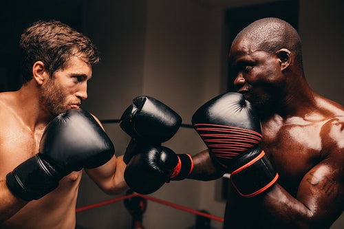 Two determined male boxers facing off