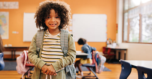 Young male student smiling and looking at camera on first day of co-ed class
