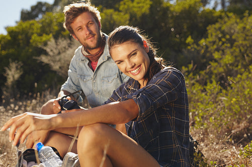 Happy couple taking a break on hike