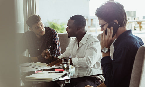 Three men having a business discussion in a meeting