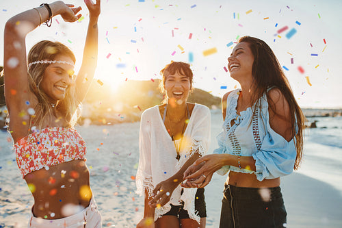 Three young women having fun at beach party