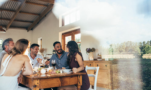 Friends enjoying meal at home together