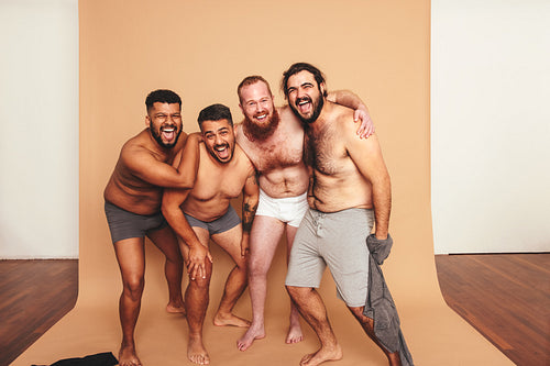 Friends having fun with their shirts off