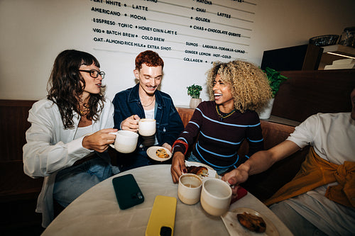 Young friends meeting in a cafe