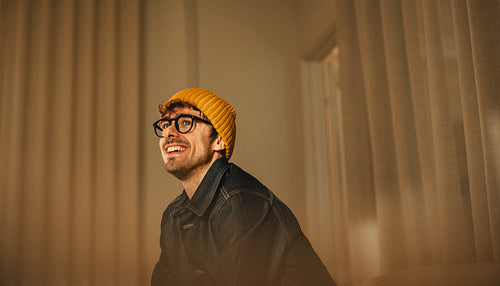 Man poses in an office for a creative business portrait