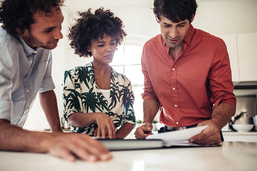 Couple reviewing contract papers with real estate agent