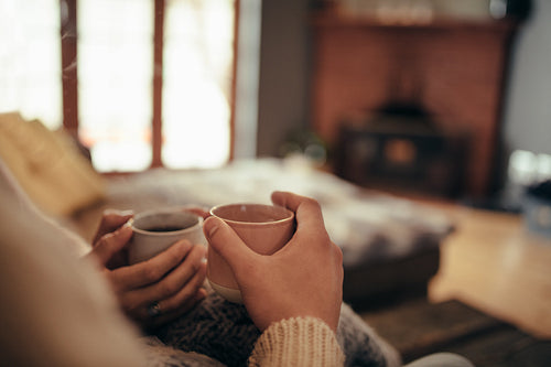 Couple with coffee sitting at home