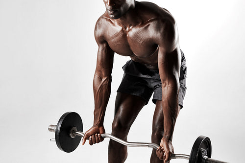 Male bodybuilder exercising with a barbell