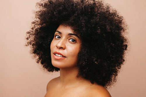 Beautiful woman with Afro hair looking at the camera confidently