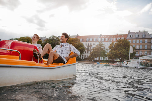 Teenage guys enjoying boating in the lake
