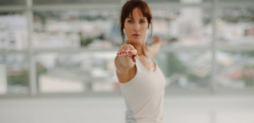 Woman stretching her arms at gym