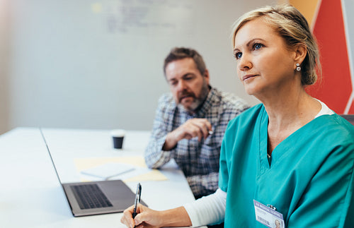 Mature female medical professional in meeting