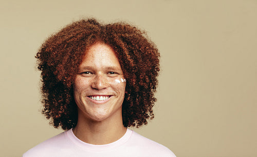 Skincare with beauty cream: Portrait of a man with ginger hair and freckles