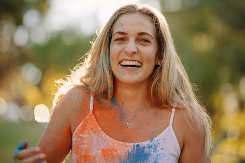 Woman playing holi with powder colours