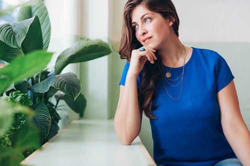 Attractive young woman daydreaming