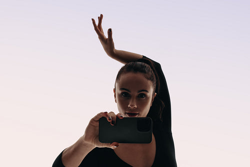 Content creator recording her dance routine with her smartphone