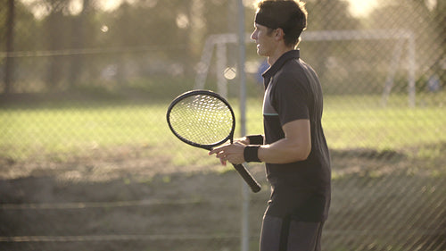 Tennis player practicing forehands and backhands on hardcourt