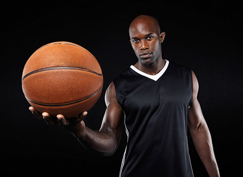 Confident young basketball player with a ball