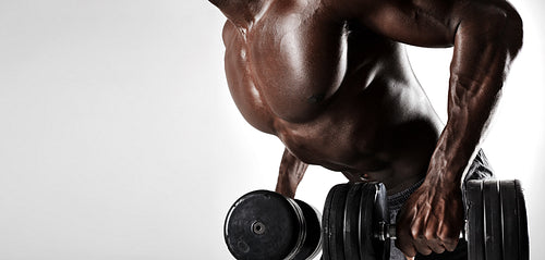 Bodybuilder exercising with dumbbells
