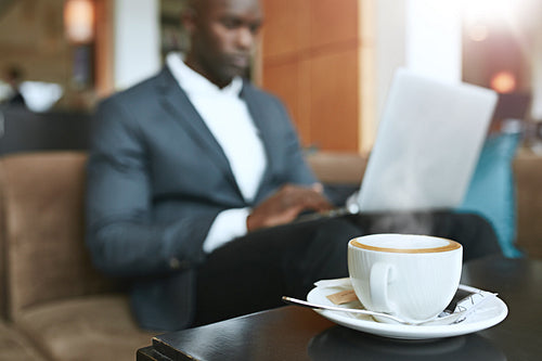 Refreshing hot cup of coffee on table at hotel lobby