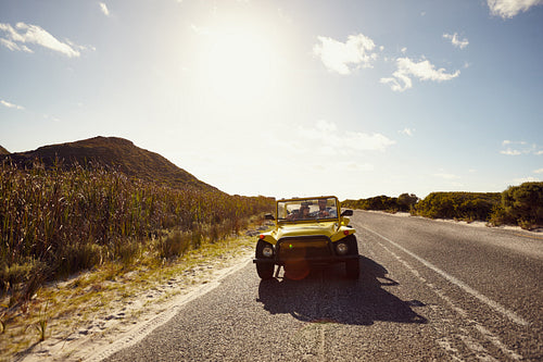 Young friends on road trip in a buggy car