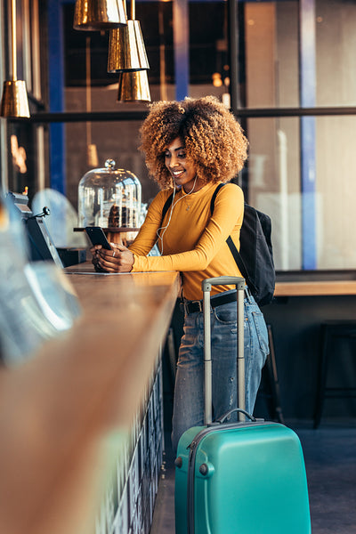 Woman tourist standing at the billing counter making payment