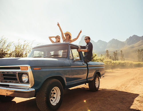 Friends at the back of a pick up truck having fun