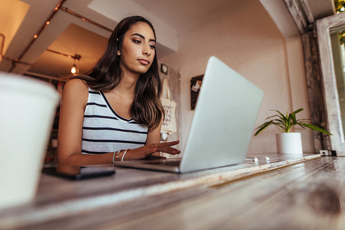 Woman blogger at work on her laptop computer
