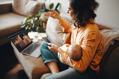Mother with baby on couch during video call