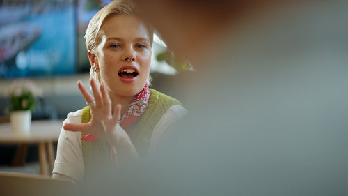 Listening as woman reacts during a business meeting in a cafe coworking space