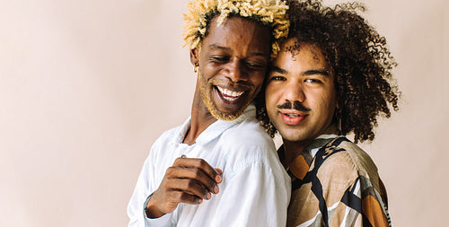 Beautiful gay couple standing in a studio