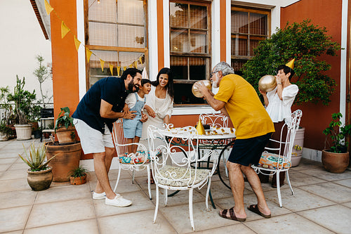 Family celebrating with balloons and fun at an outdoor party